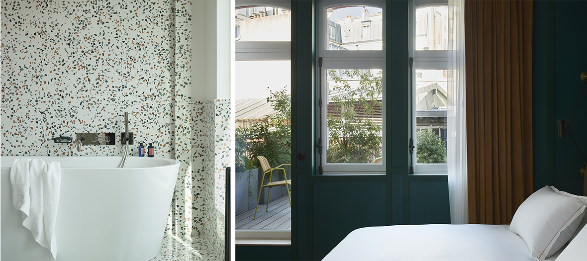 Hôtel Ballu Paris : Salle de bain en terrazzo avec baignoire îlot et lumière naturelle. Chambre cosy avec vue sur une terrasse végétalisée.